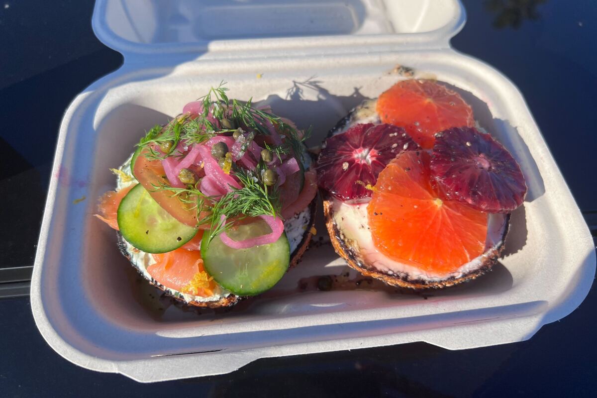 Smoked salmon and more on one bagel half; blood orange and grapefruit, cream cheese and more on the other.
