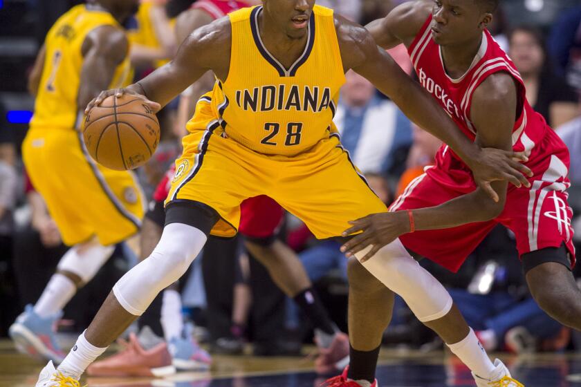 Pacers center Ian Mahinmi (28) keeps the ball protected as he works against the defense of Rockets forward Clint Capela (15) during the first half.