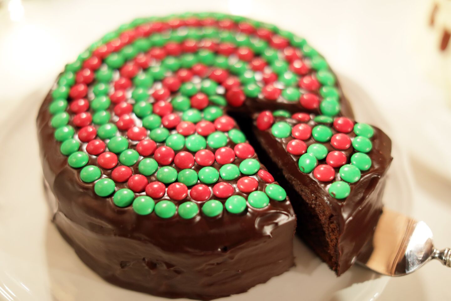 A chocolate cake topped with red and green candy.