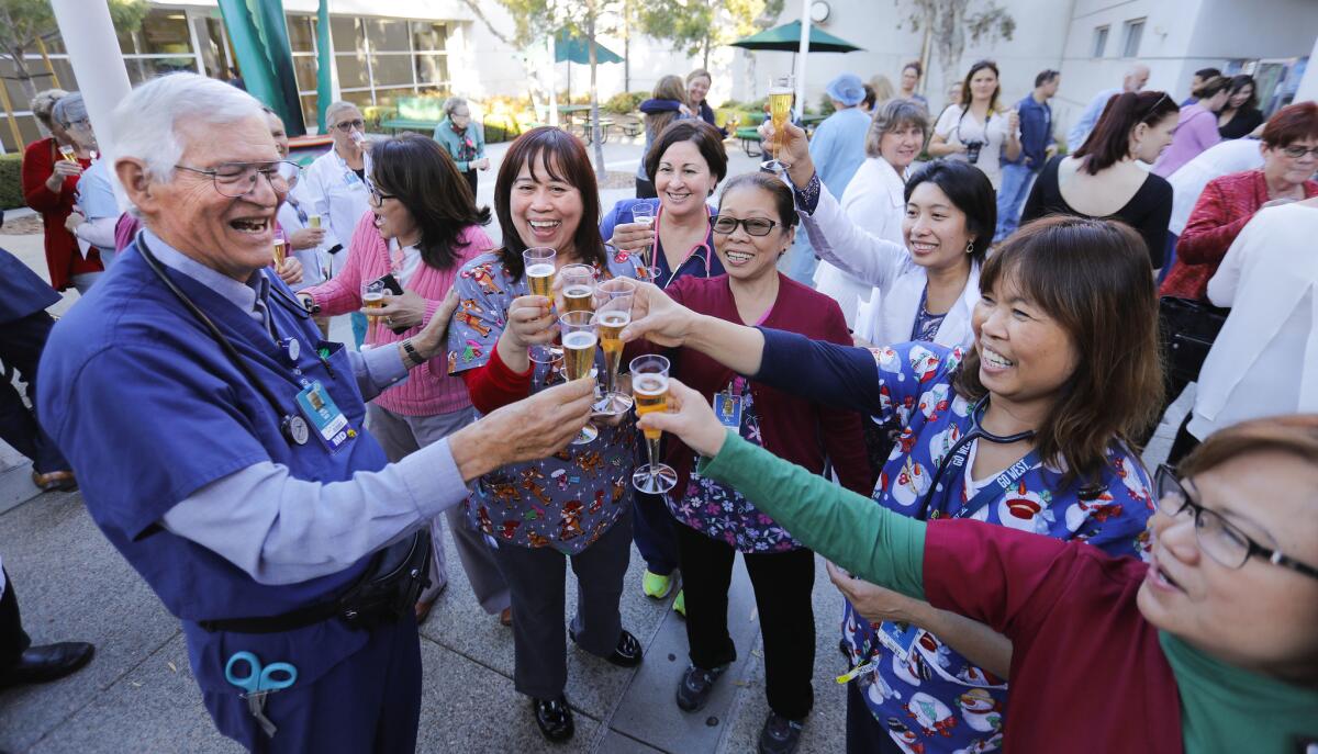 Dr. Melvin Ochs, left, retired last week after a storied career of nearly 50 years at Scripps Mercy Hospital Chula Vista where he was the emergency department director. He celebrated with emergency room nurses and staff during a small gathering at the hospital.