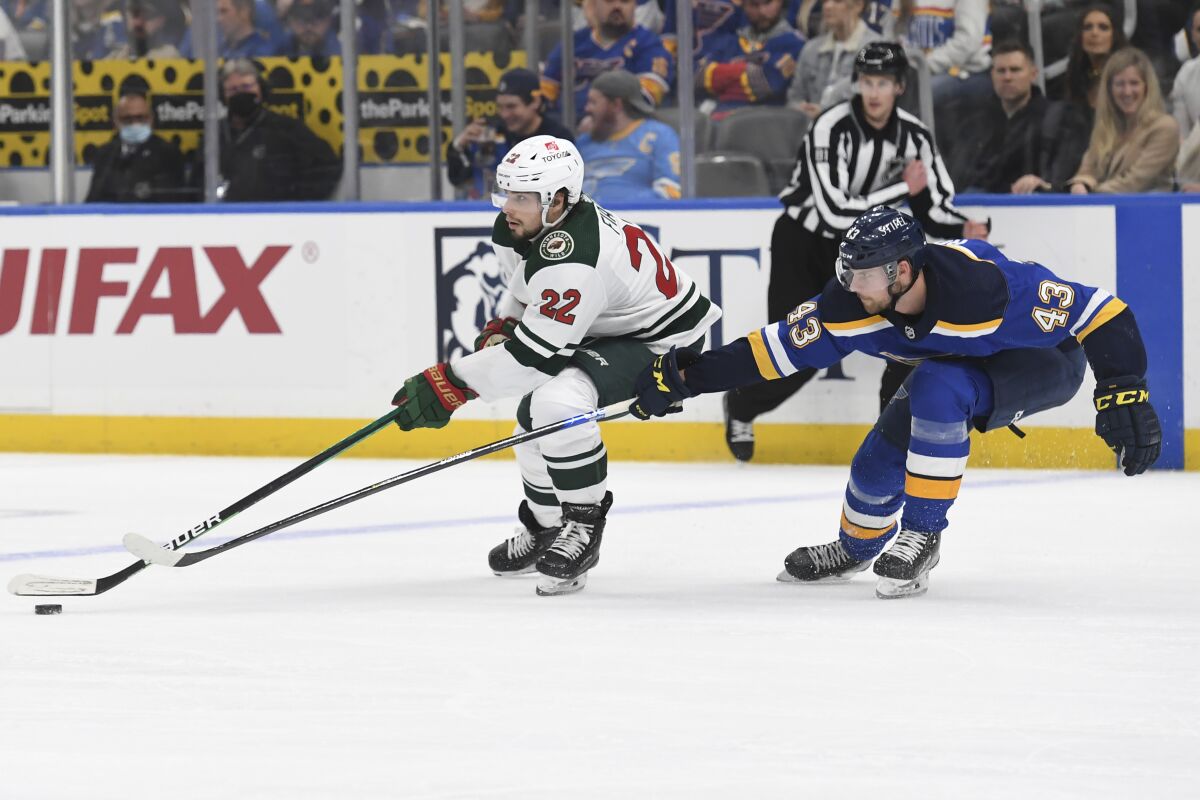 Minnesota Wild's Kevin Fiala (22) is defended by St. Louis Blues' Calle Rosen (43) during the third period in Game 3 of an NHL hockey Stanley Cup first-round playoff series Friday, May 6, 2022, in St. Louis. (AP Photo/Michael Thomas)