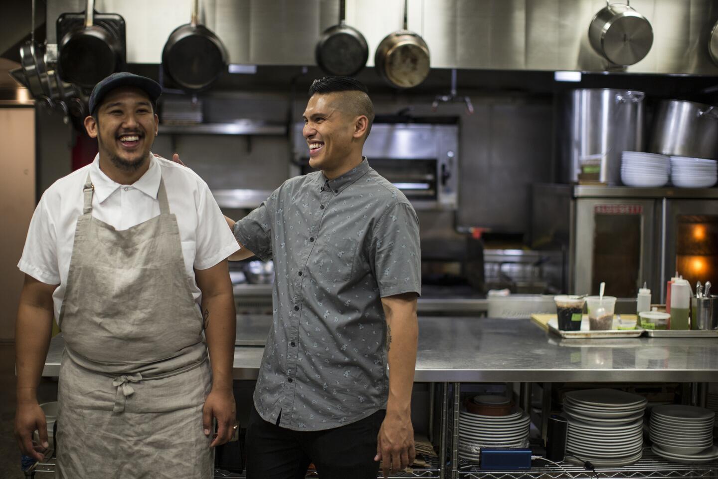 Chef Chad Valencia, left, and brother Chase in the kitchen at Lasa.