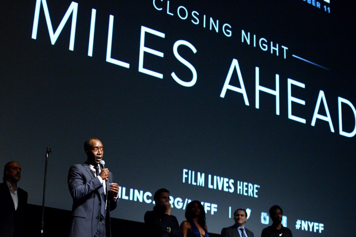 Filmmaker Don Cheadle, left, speaks on stage at the closing night gala screening of "Miles Ahead."