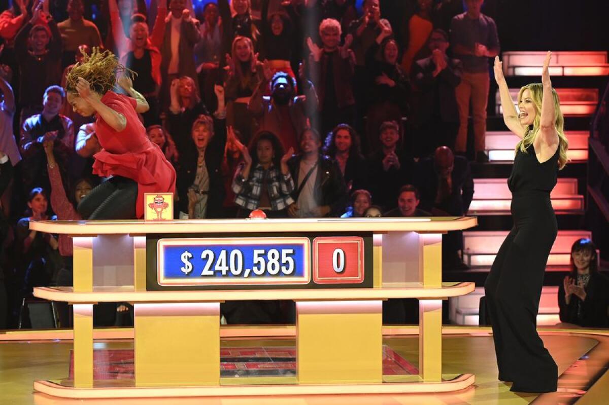 FaLawna Barton jumps for joy en route to a $265,585 win on ABC's "Press Your Luck" show. Host Elizabeth Banks cheers her on.