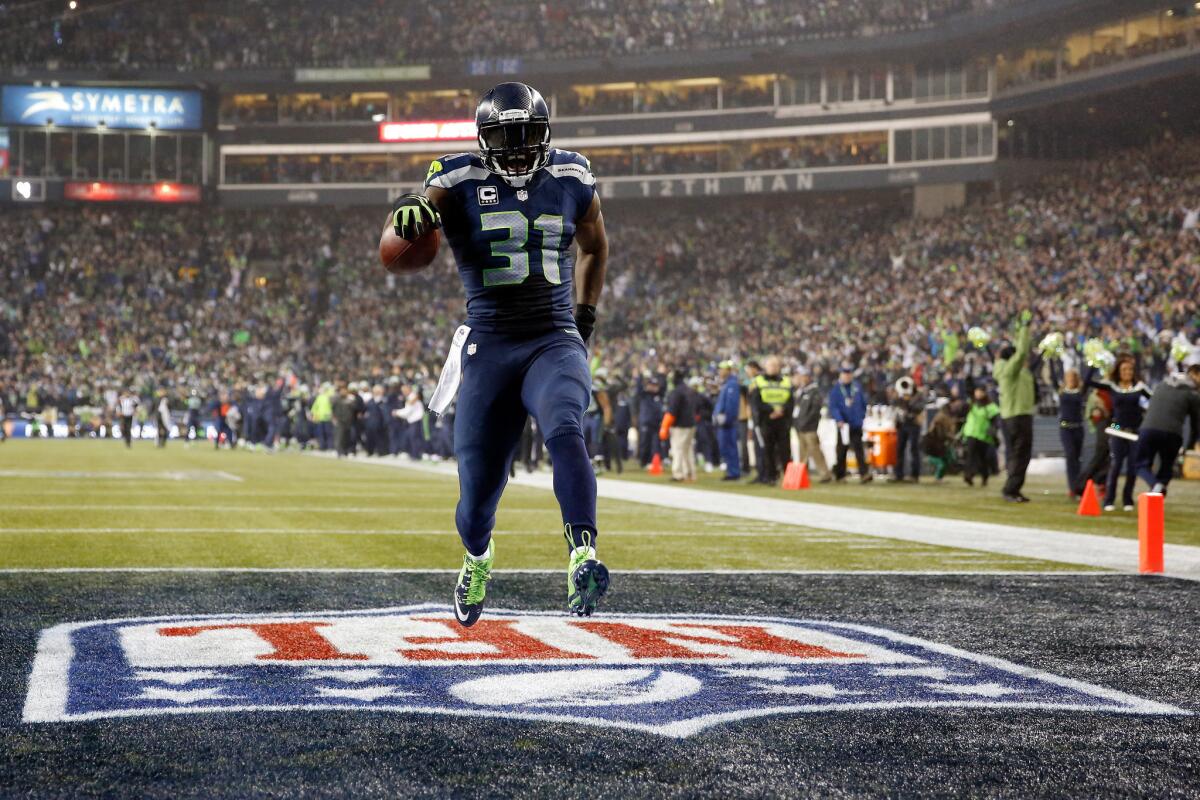 Seahawks safety Kam Chancellor strolls into the end zone following a 90-yard interception return for a touchdown in the NFC Divisional Playoffs.
