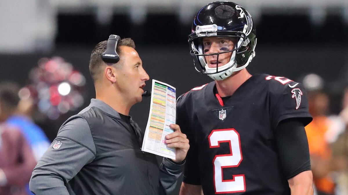 Atlanta Falcons offensive coordinator Steve Sarkisian confers with quarterback Matt Ryan during a timeout during the second half of a game against the Buffalo Bills on Oct. 1, 2017.