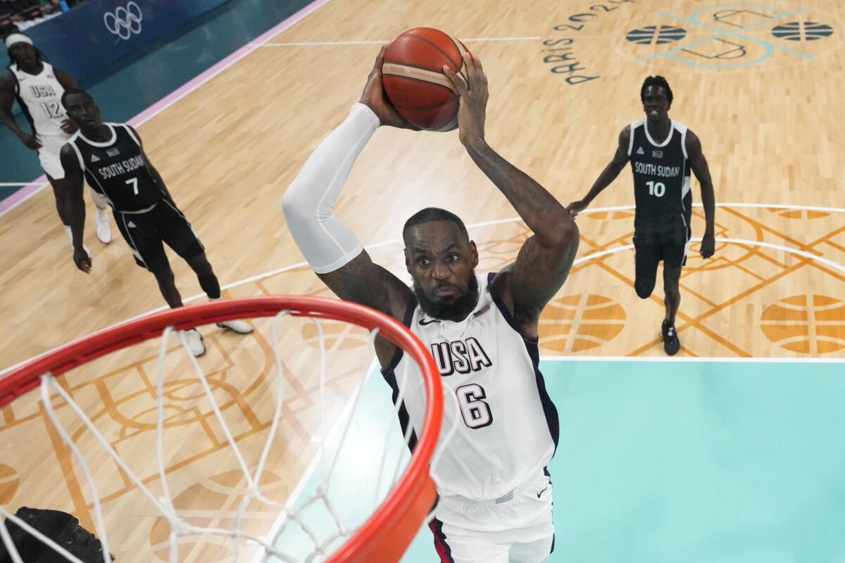 LeBron James goes up for a dunk against South Sudan during a Summer Olympics group win Wednesday in Lille, France.