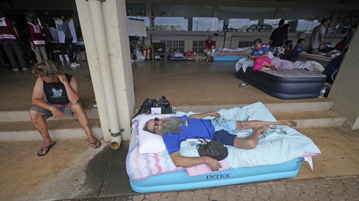 Thomas Leonard lies on an air mattress at an evacuation center at the War Memorial Gymnasium.