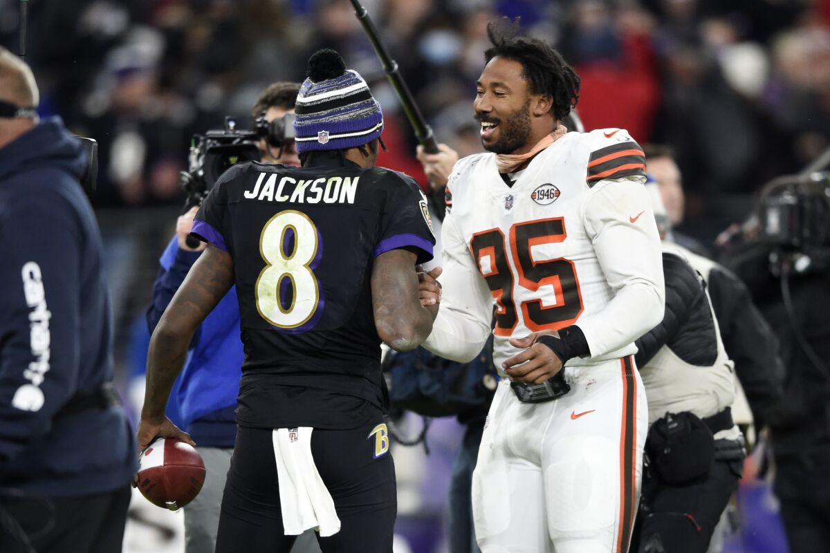 Baltimore Ravens quarterback Lamar Jackson (8) talks with Cleveland Browns Cleveland Browns defensive end Myles Garrett (95) at the end of an NFL football game, Sunday, Nov. 28, 2021, in Baltimore. The Ravens won 16-10. (AP Photo/Gail Burton)