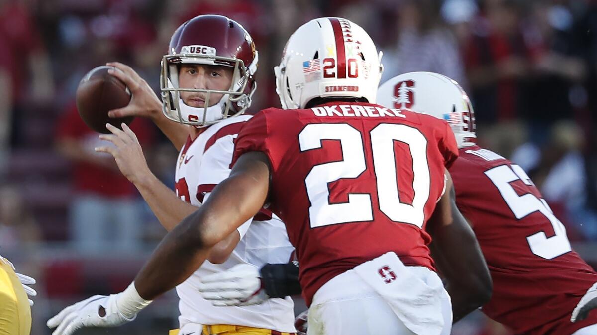 USC quarterback Matt Fink (19) throws a pass under pressure by Stanford linebacker Bobby Okereke (20) during the first half on Saturday.