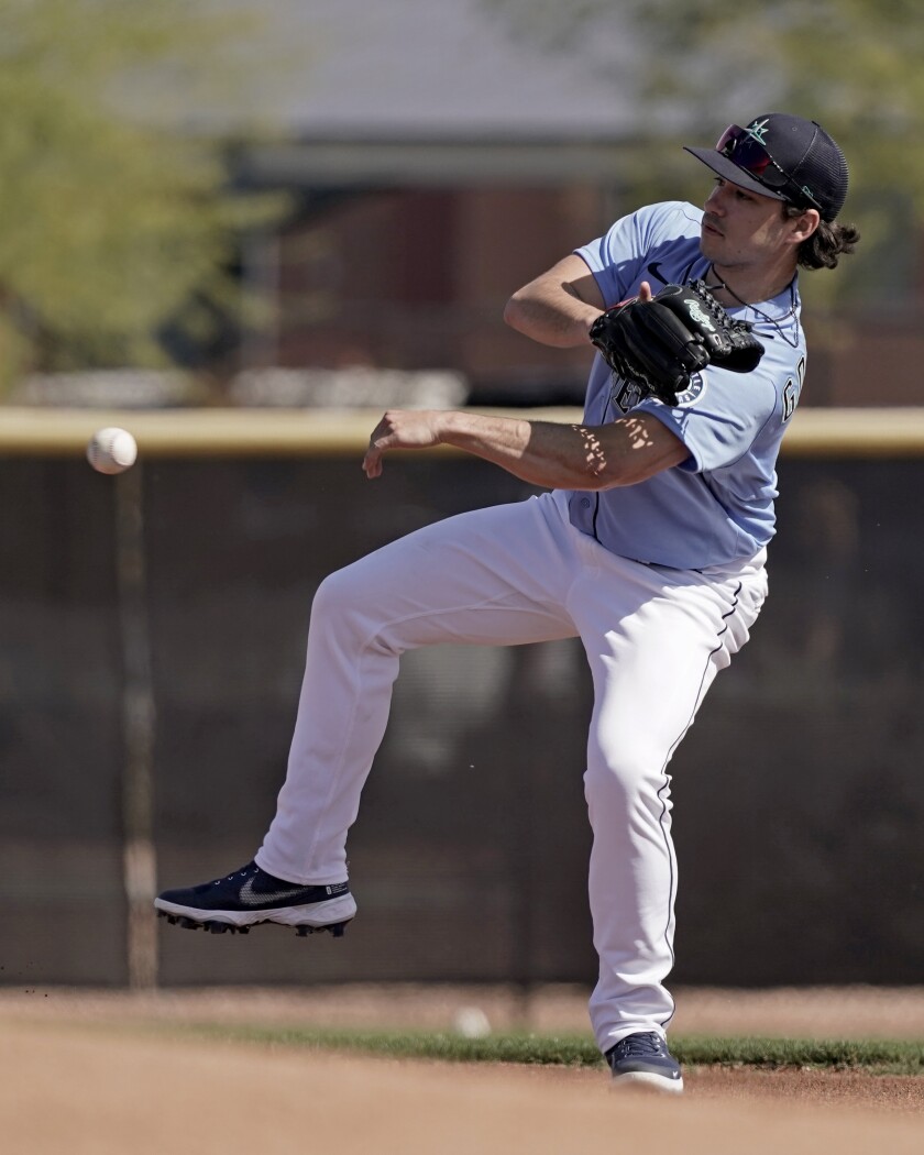 Seattle Mariners pitcher Marco Gonzales throws a ball during spring training baseball practice Wednesday, March 16, 2022, in Peoria, Ariz. (AP Photo/Charlie Riedel)