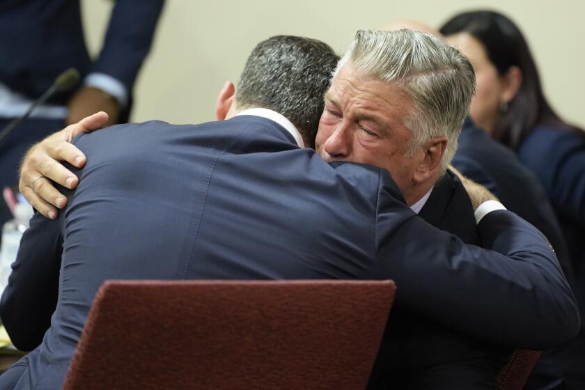 Actor Alec Baldwin, right, hugs his attorney Alex Spiro after the judge threw out the involuntary manslaughter case for the 2021 fatal shooting of cinematographer Halyna Hutchins during filming of the Western movie "Rust," Friday, July 12, 2024, in Santa Fe, N.M. (Ramsay de Give/Pool Photo via AP)
