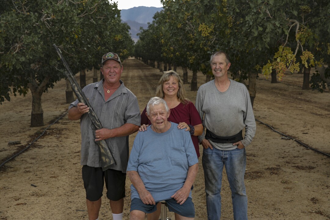 Family members pose in an orchard