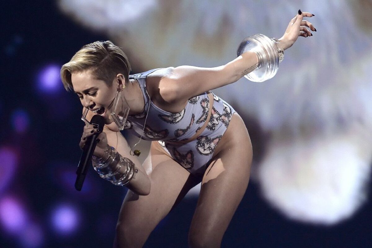 At the 2013 American Music Awards, Miley performed another rendition of the power ballad "Wrecking Ball" — this time with the help of a flying, lip-synching space kitten. Her tiny two-piece decorated with kitten faces jibed perfectly with the theme. Miley left viewers scratching their heads, and sparking a heap of buzz.