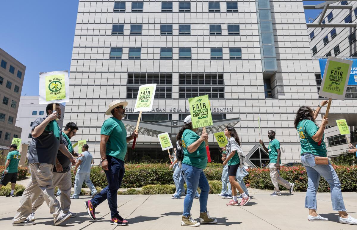  Demonstrators hold picket signs