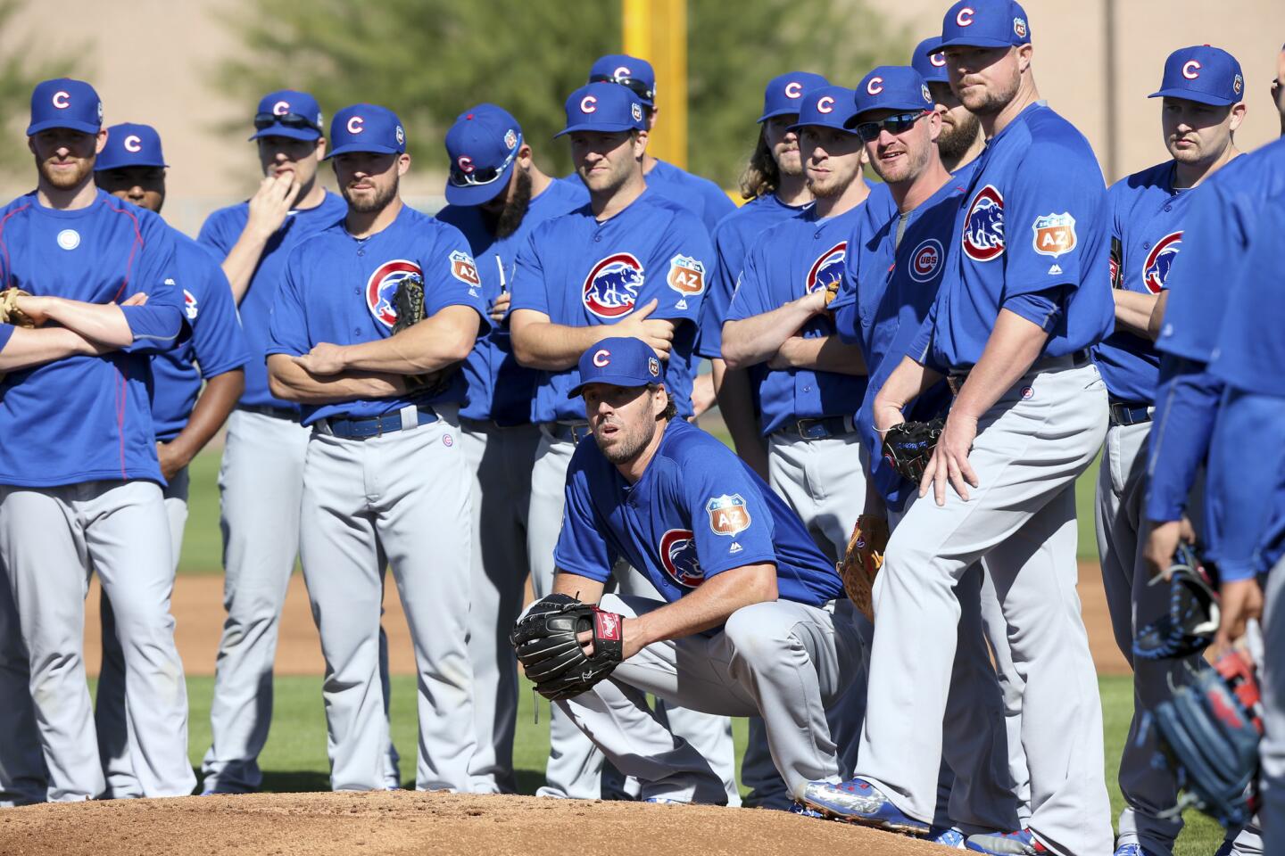 John Lackey kneels while waiting with other players to meet with manager Joe Maddon, Feb. 24, 2016.