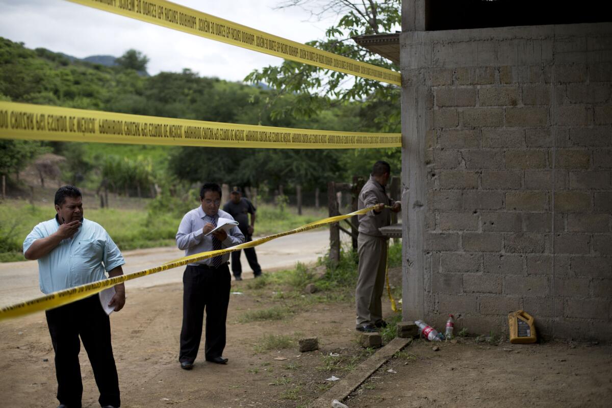 State authorities seal off a warehouse in Tlatlaya, Mexico, that was the site of a shootout between Mexican soldiers and gang members.