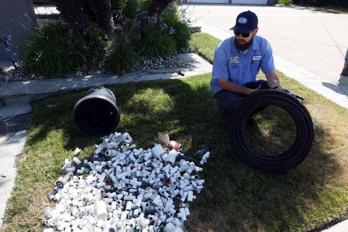 Derek Krauss with the Las Virgenes Municipal Water District inspects a Calabasas home.