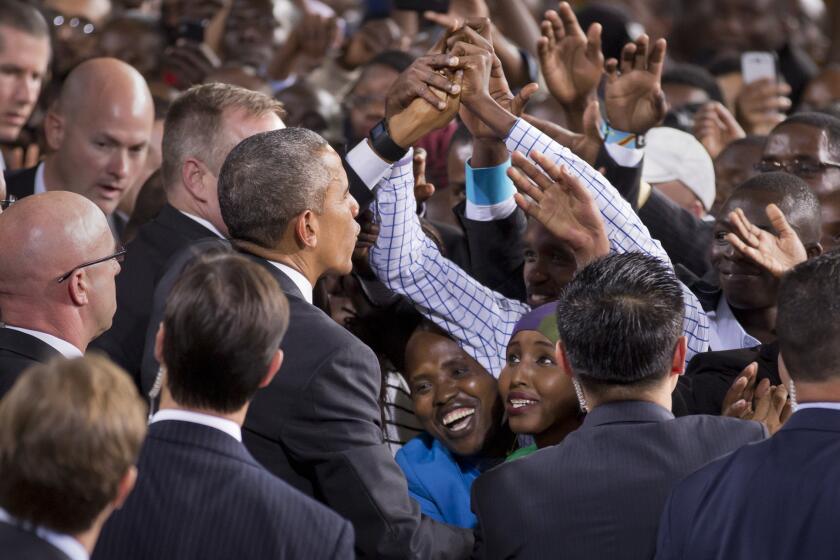 Two Kenyan women look up as President Obama reaches out to shake hands as he departs after delivering a speech at the Safaricom Indoor Arena in the Kasarani area of Nairobi, Kenya, on Sunday.