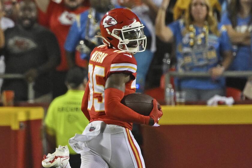 Chiefs corner Jaylen Watson (35) looks back as he returns an interception for a score against the Chargers in Week 2.