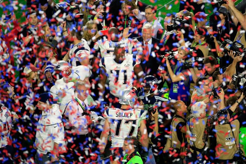 Patriots players celebrate as confetti falls at University of Phoenix Stadium following their 28-24 victory over the Seahawks in Super Bowl XLIX.