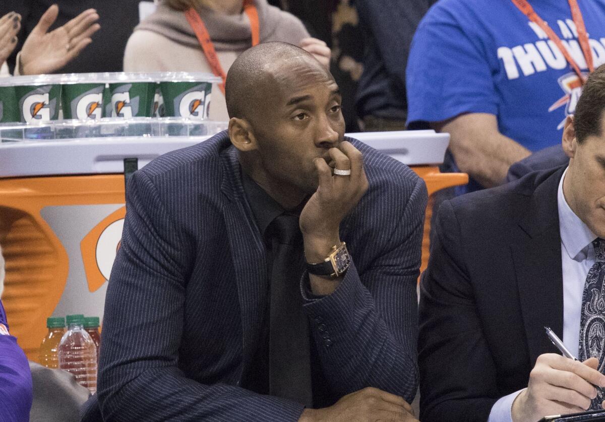 Kobe Bryant sits on the bench watching game action against Oklahoma City on Saturday.
