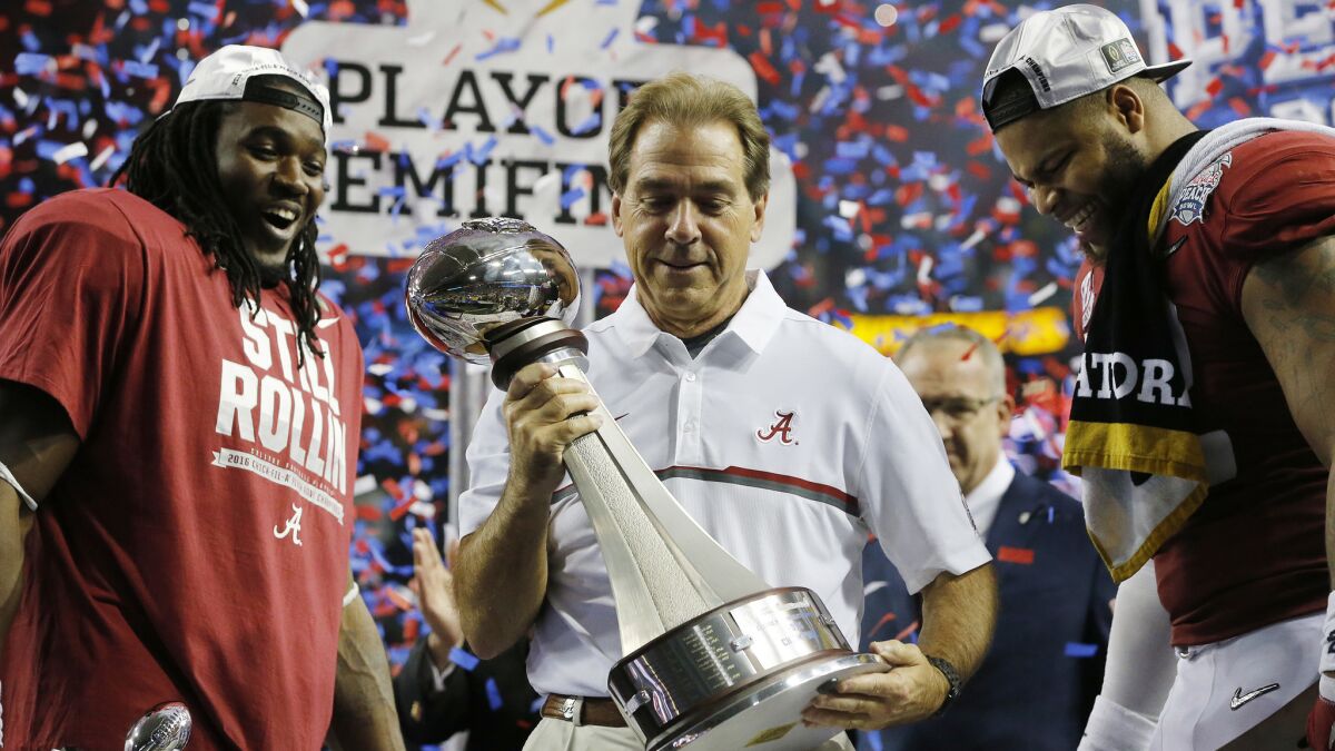 Coach Nick Saban, flanked by Bo Scarbrough, left, and Ryan Anderson celebrates after Alabama's victory in the Peach Bowl on Saturday.