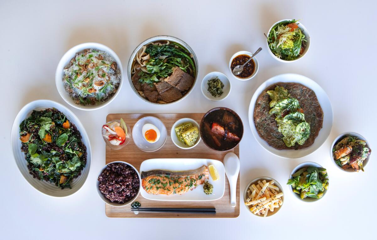 A spread of dishes, including the signature beef noodle soup (top center) at Yang's Kitchen.