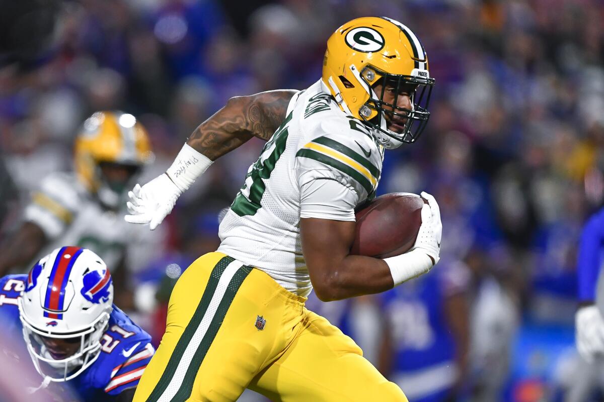 Green Bay running back AJ Dillon runs with the ball during the second half against the Buffalo Bills.