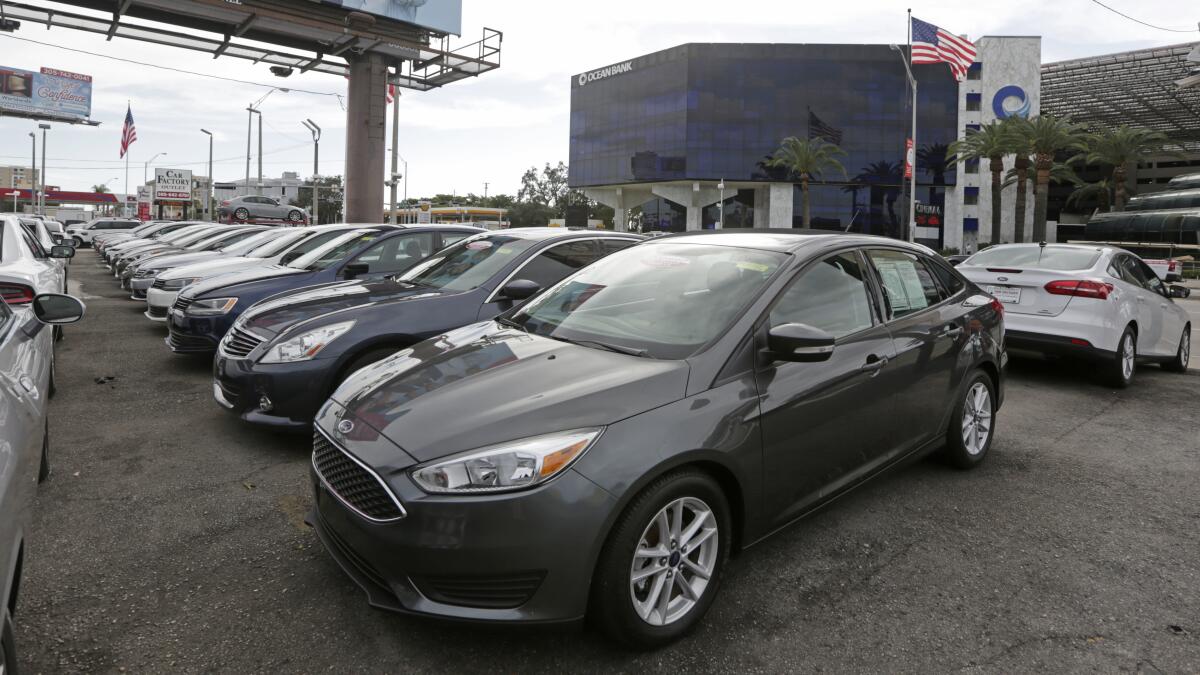 This photo shows used cars sitting on a dealership lot