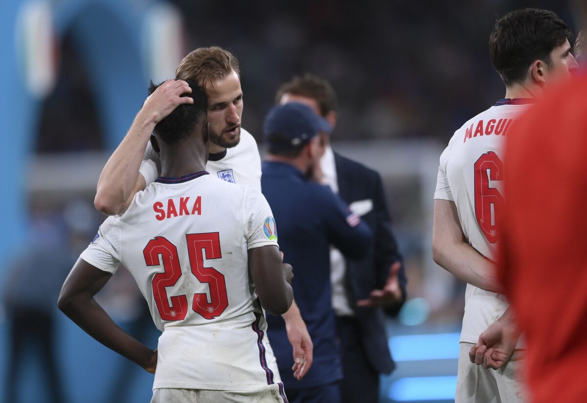 England's Harry Kane puts his hand on the back of Bukayo Saka's head