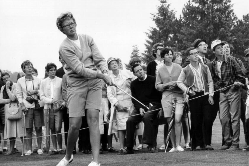 In this 1967 file photo, the gallery follows Mickey Wright's iron shot from the fairway at the Toronto Golf Club.