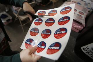 SANTA MONICA, CA - SEPTEMBER 14: Vote center lead Rachel Hadlock-Piltz, prepares "I VOTED" stickers for voters casting their ballots in a vote center at Santa Monica College as polls open Tuesday morning for Californians to decide whether Gov. Gavin Newsom should be removed from office and, if so, who should replace him in a recall election. "I really enjoy this part of the job," Rachel said. Santa Monica College on Tuesday, Sept. 14, 2021 in Santa Monica, CA. (Al Seib / Los Angeles Times).