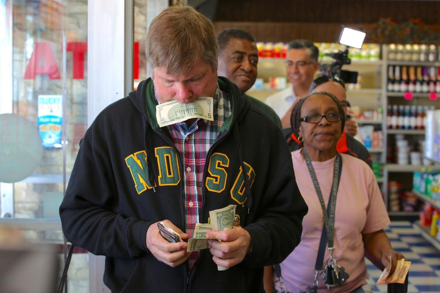 Mark Boesen stands in line to puchase Powerball lottery tickets at Bluebird Liquor store in Hawthorne on Feb. 11.
