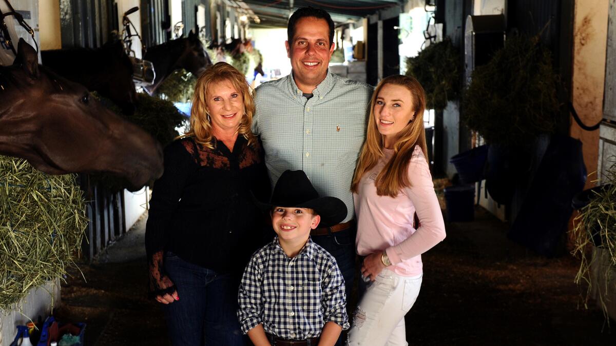 Trainer Phil D'Amato at Santa Anita with fiancee Sherri Marr, her daughter Jessica, and Ryan, the boy D'Amato and Marr are adopting.