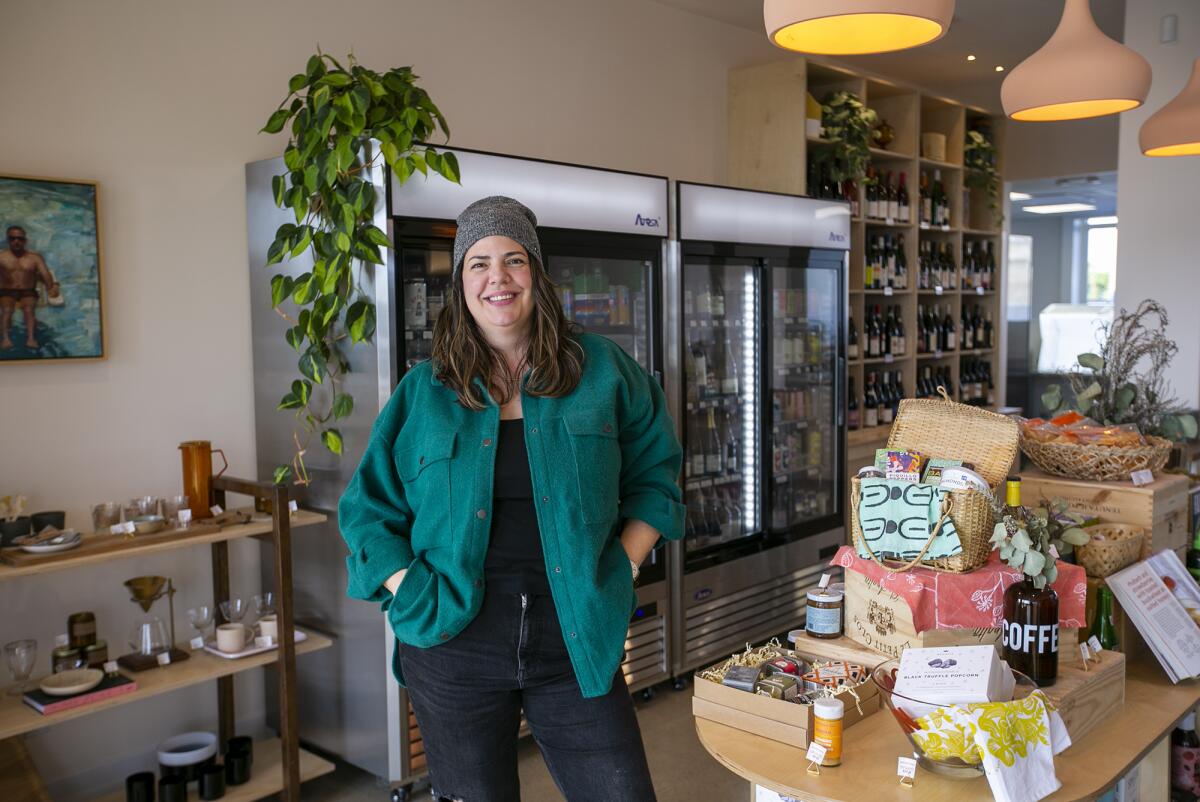 Gabrielle Dion, the owner of the Mixing Glass and Market, stands inside the Costa Mesa business.