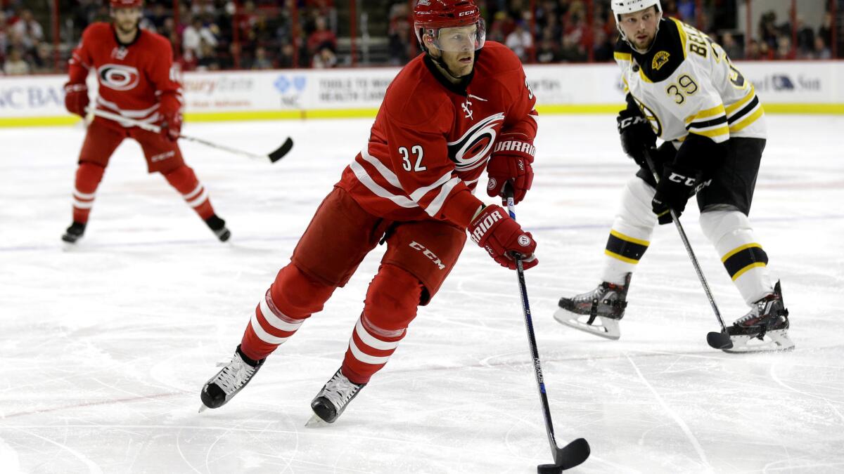 Kris Versteeg works the puck up ice against the Bruins during a game for the Hurricanes on Feb. 26.