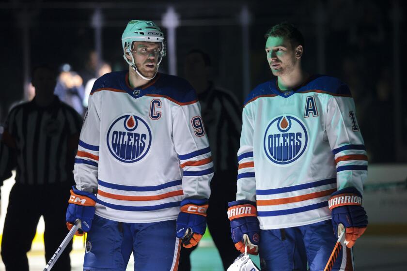 Edmonton Oilers center Connor McDavid, left, and left wing Zach Hyman (18) stand together before a preseason NHL hockey game against the Seattle Kraken, Monday, Oct. 2, 2023, in Seattle. (AP Photo/Jason Redmond)