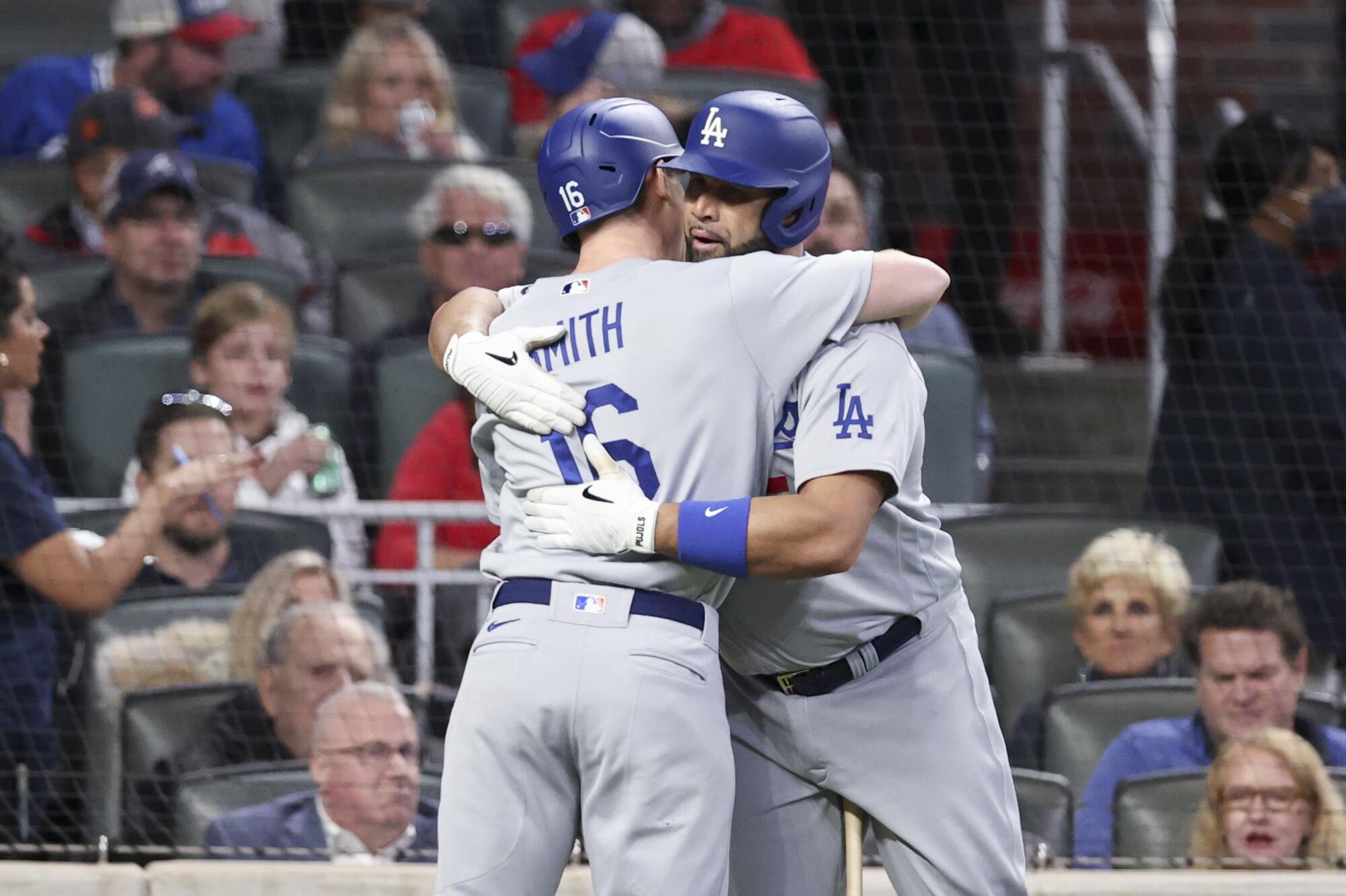 Los Angeles Dodgers' Will Smith, left, celebrates with Albert Pujols after a solo home run 