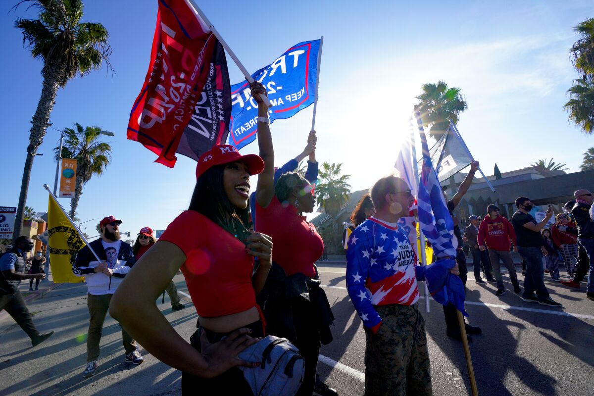 Trump supporters stand along Mission Boulevard in Pacific Beach Saturday for the "Patriot March."
