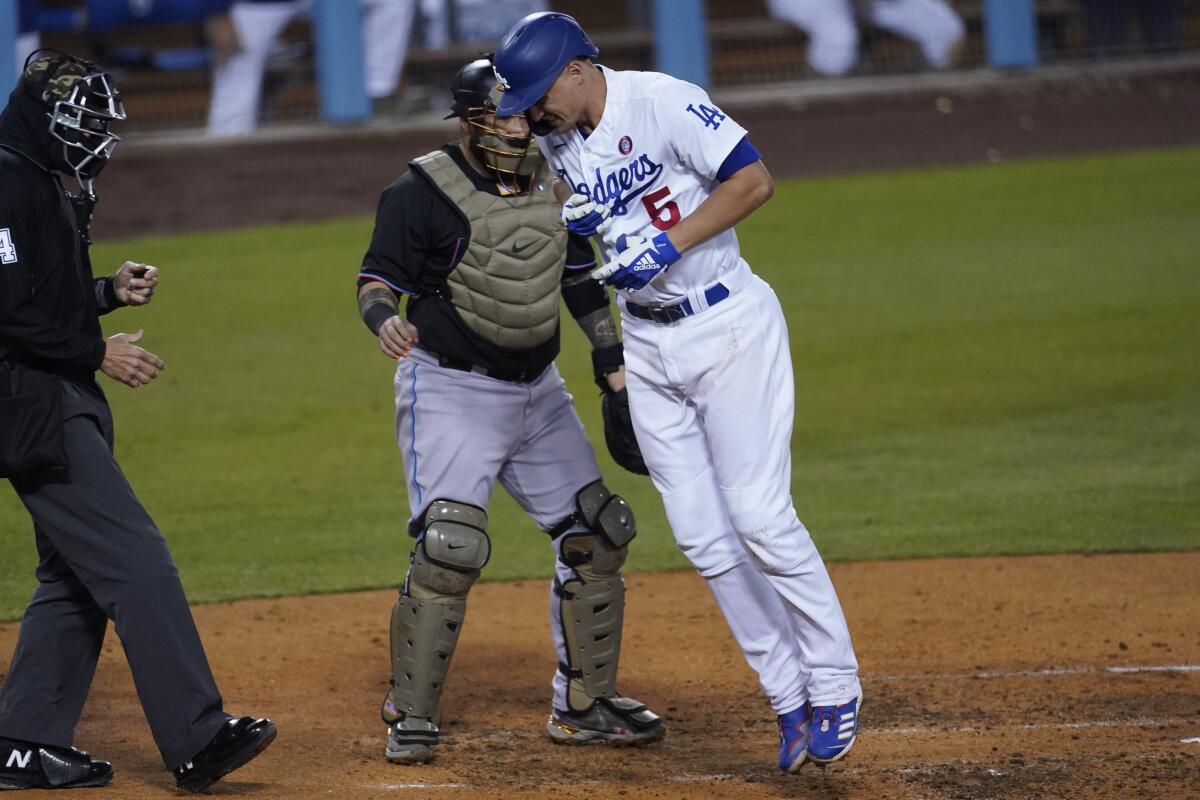 Los Angeles Dodgers' Corey Seager (5) reacts after being hit by a pitch from Miami Marlins relief pitcher Ross Detwiler during the fifth inning a baseball game Saturday, May 15, 2021, in Los Angeles. (AP Photo/Ashley Landis)