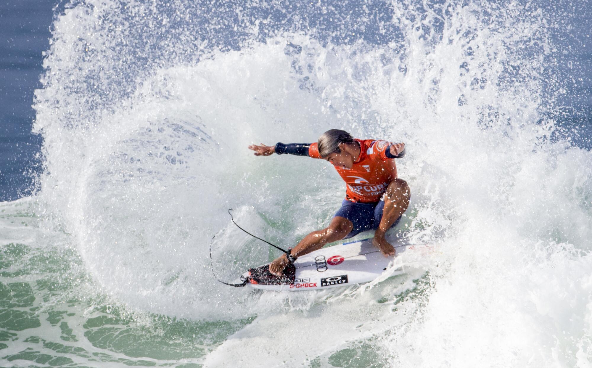 Kanoa Igarashi of Huntington Beach does a slashing turn during a match at the WSL Finals.