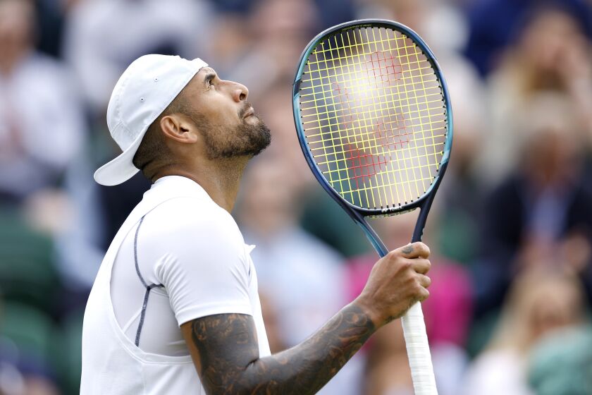 Australia's Nick Kyrgios looks up after beating Serbia's Filip Krajinovic, in a second round men's single match on day four of the Wimbledon tennis championships in London, Thursday, June 30, 2022. (Steve Paston/PA via AP)