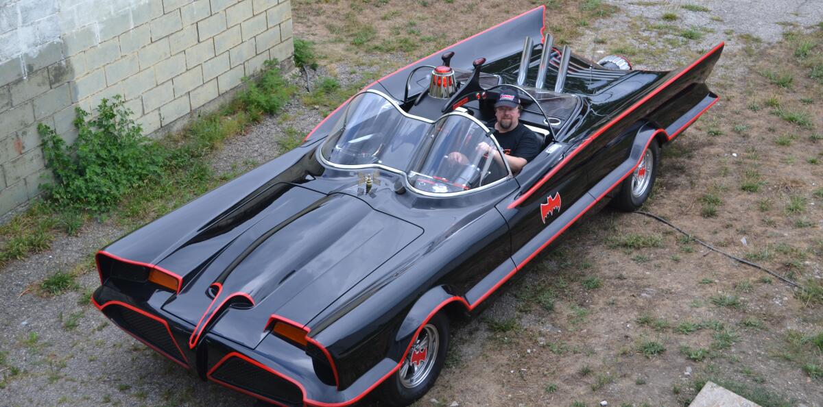 Mark Racop, owner of Fiberglass Freaks in Logansport, Ind., sits in one of his custom-made Batmobiles.