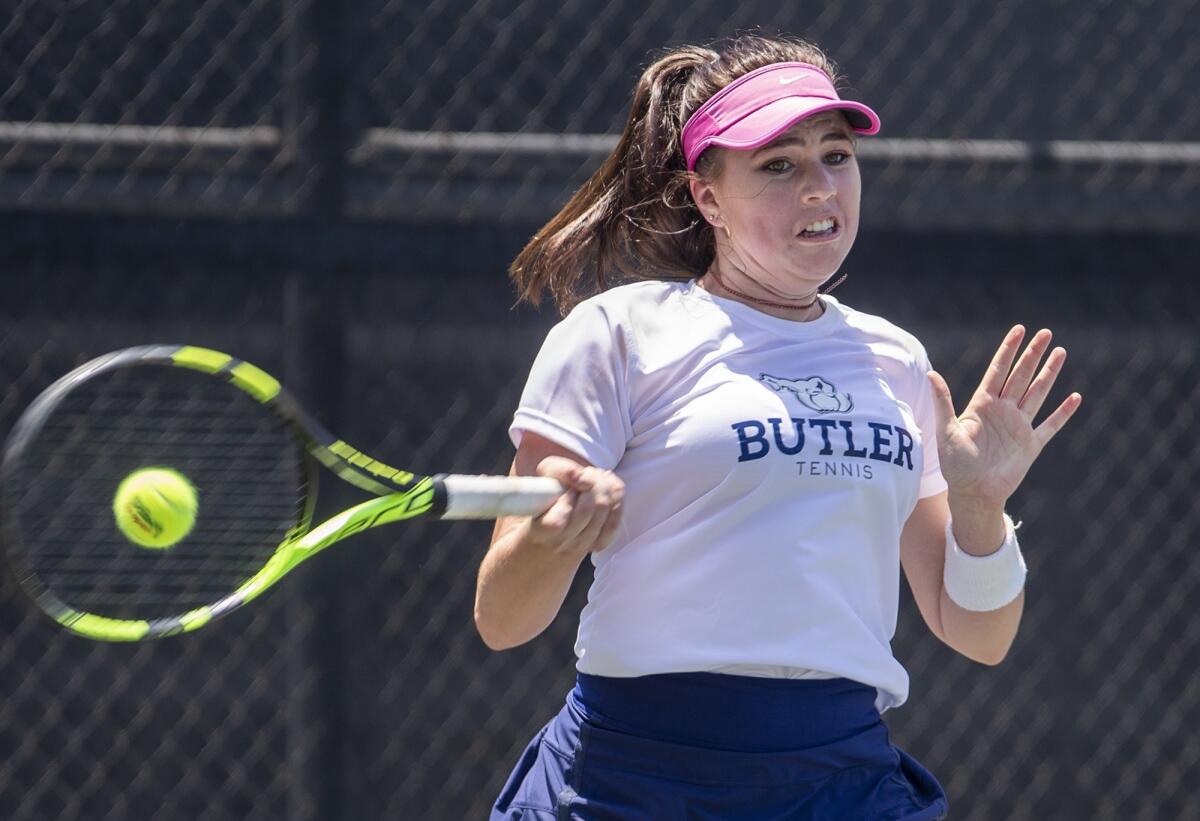 Roxy MacKenzie of Newport Coast returns a shot to Erica Ekstrand of Santa Monica in the girls' 18-and-under round of 64 singles match at the 117th USTA Southern California Junior Sectional Championships on Wednesday at Los Caballeros Sports Village in Fountain Valley.