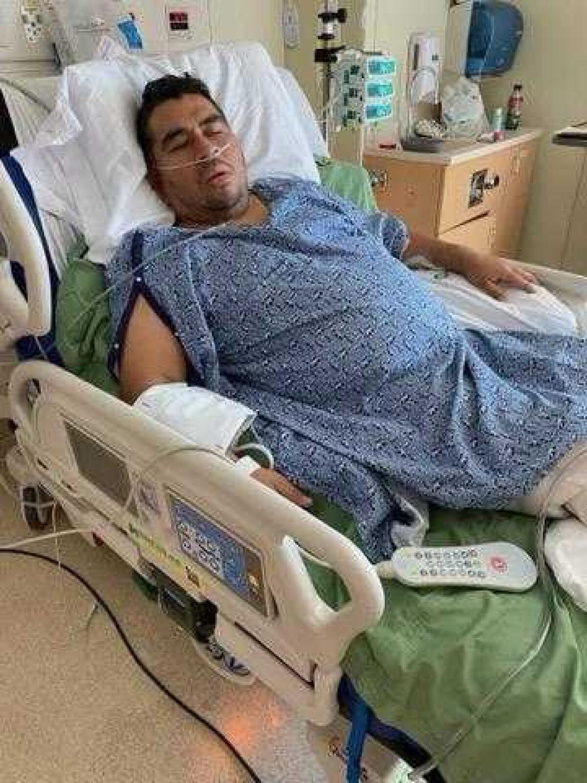 Luis Hernandez lies in a hospital bed.