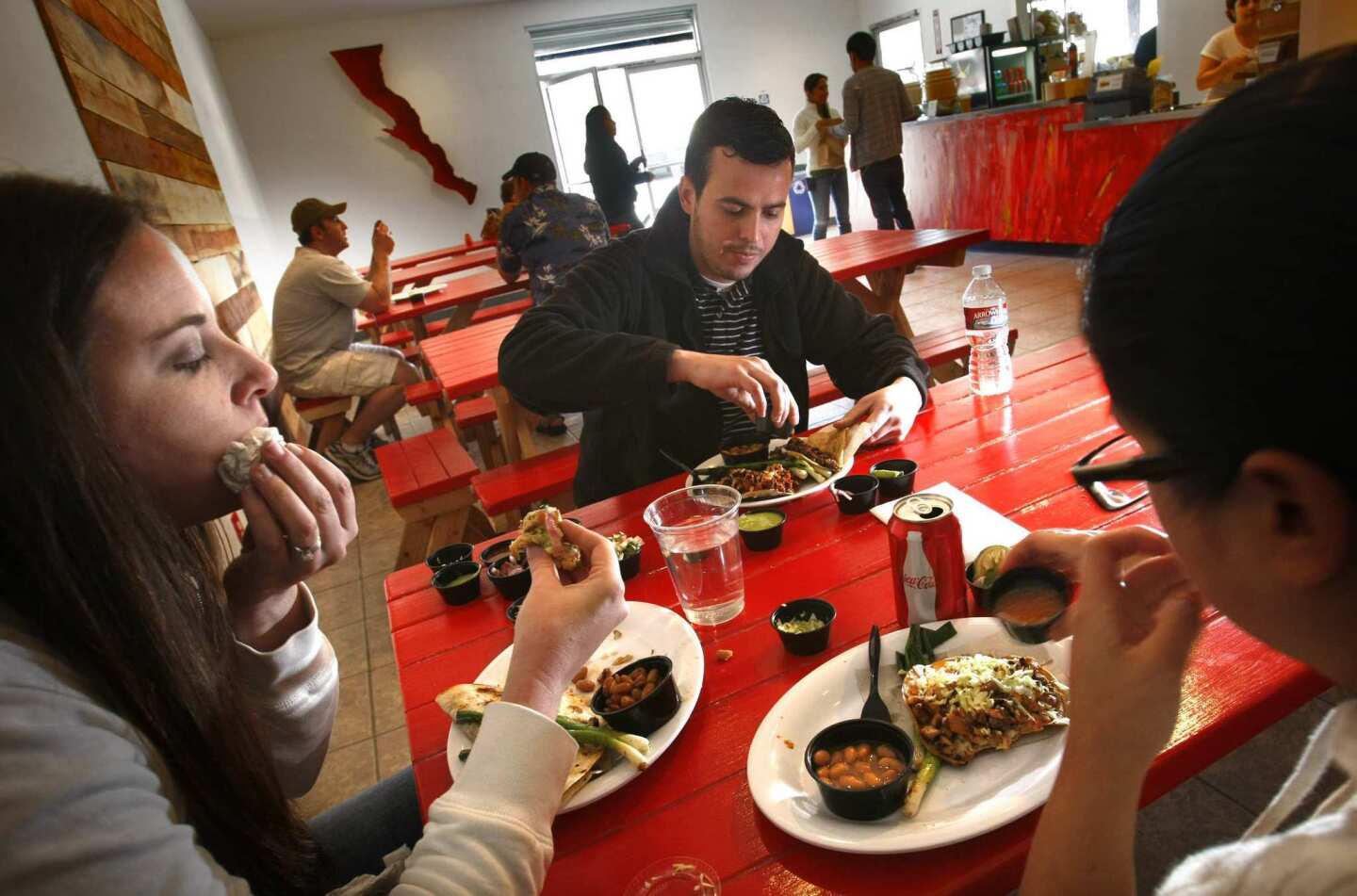 The Baja-style food is served in a spiffed-up setting that might be found in Mexicali. Dining on the just-across-the-border fare are, from left, Kristen Beissel, Rafael Patricio and Evelyn Guillen.