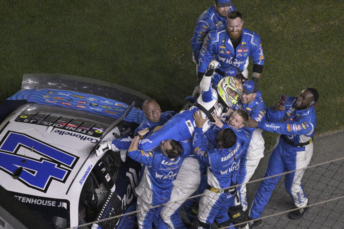 Ricky Stenhouse Jr. dives onto his crew members after winning the Daytona 500 on Sunday.