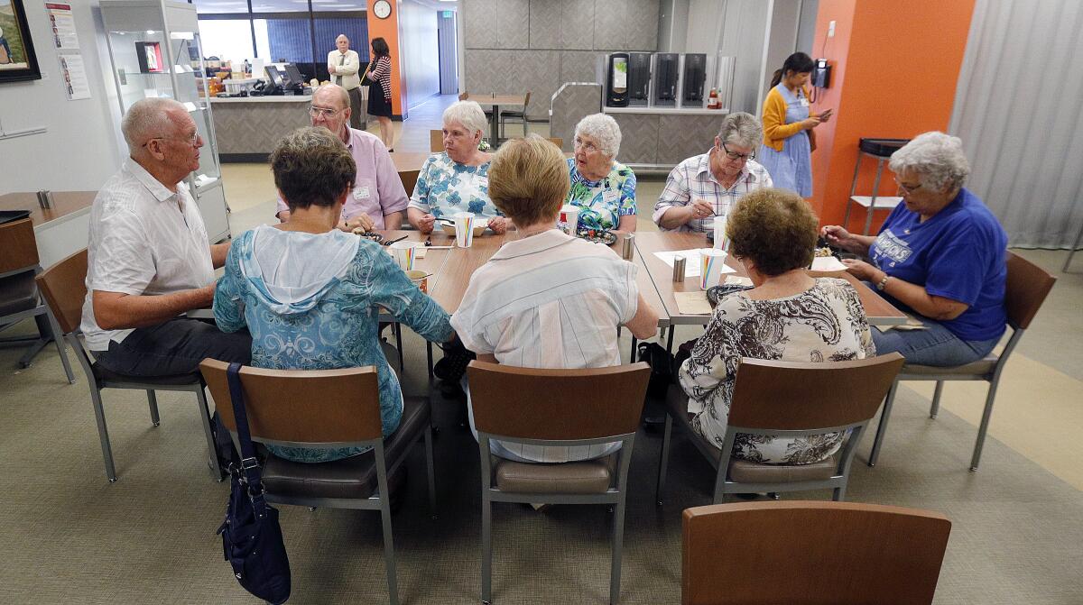 A table of friends join Phil Downs, at left, for dinner together at USC Verdugo Hills Hospital on Aug. 22.