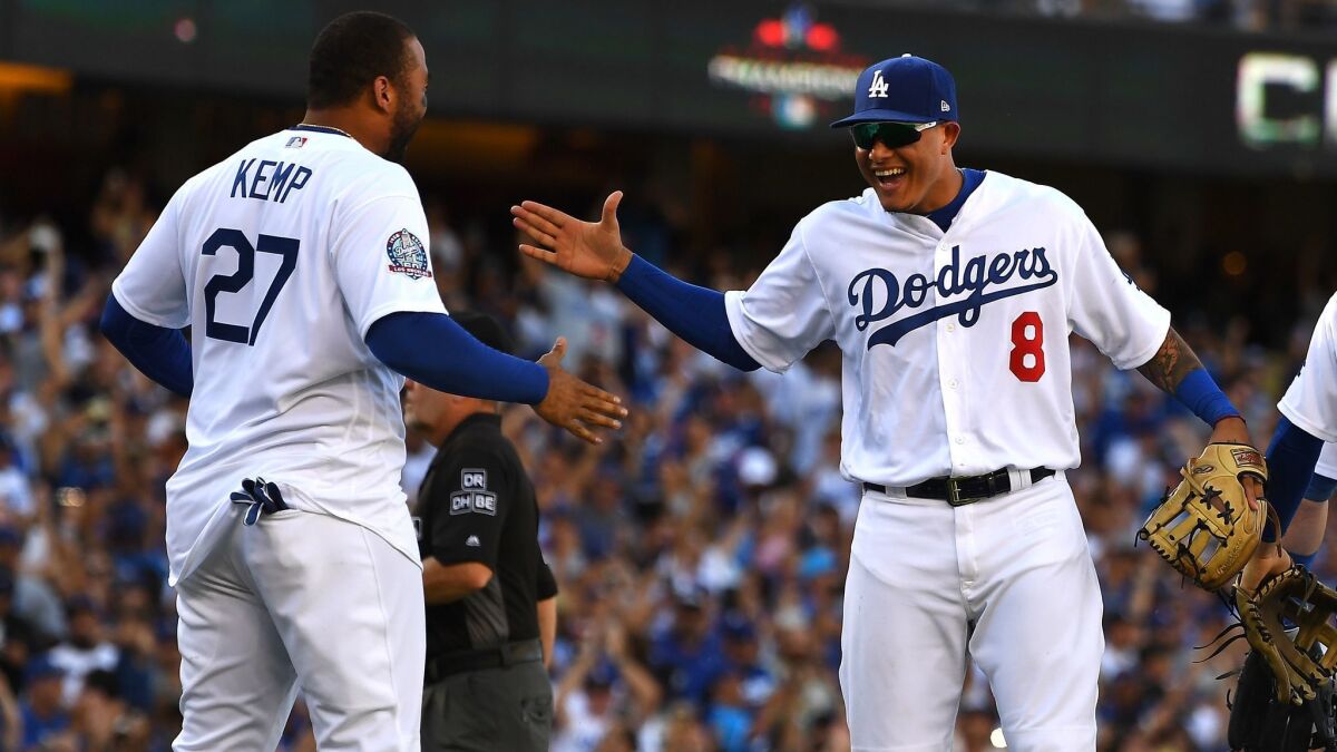 Manny Machado, right, and Matt Kemp enjoy the moment after the Dodgers beat the Rockies on Monday to win the National League West title.